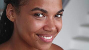 Close-up portrait of a beautiful happy multi-ethnic young woman rejoicing and expressing happiness, enjoyment and satisfaction looking at camera. Positive emotions video