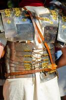 roman soldier with his back turned in lorica segmentata armor at a historical reenactment event photo