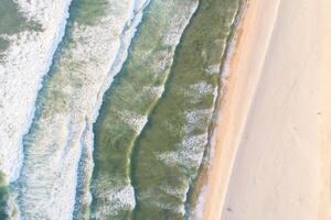 Waves on the beach as a background. Green sea water, natural background at the summer time. Aerial view, from drone zenithal image photo