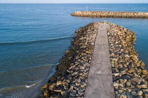 Aerial view with drone of a harbor breakwater photo