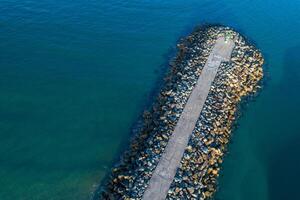 Aerial view with drone of a harbor breakwater photo