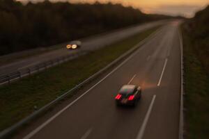 Blurred photography of cars motion in a highway at sunset photo