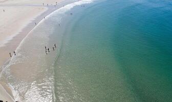 aerial drone view of a beach with people on the seashore photo