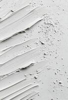Textured white surface with paint strokes and uneven spots in natural light photo