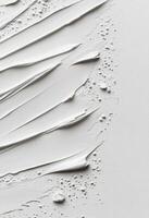 Textured white surface with paint strokes and uneven spots in natural light photo