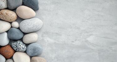 Smooth stones arranged on light surface for decorative purposes photo