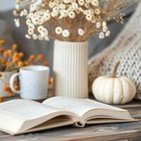 Cozy Reading Corner With Open Book, Autumn Decor, Tea, and Dried Flowers photo