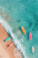 Colorful Paddleboards Lined Up on Clear Tropical Water at Sunny Beach photo