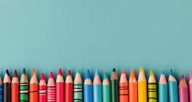 Colorful Pencils Arranged Neatly on a Light Blue Background photo