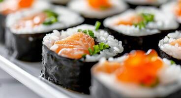 Fresh Sushi Rolls With Salmon and Cucumber on a White Plate photo