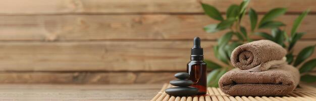 Essential Oil Bottle and Stones on Bamboo Mat in Relaxing Spa Setting photo