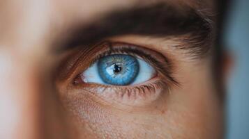 Close-Up of a Human Eye With Striking Blue Iris and Detailed Texture in Natural Light photo