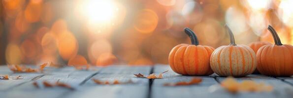 Autumn Pumpkins Displayed on Wooden Table Surrounded by Colorful Leaves photo