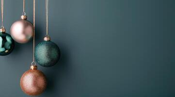 Colorful Christmas Ornaments Hanging on a Dark Green Wall photo