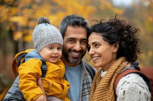 Family Enjoying Autumn Hike in Forest With Child on Father's Back photo