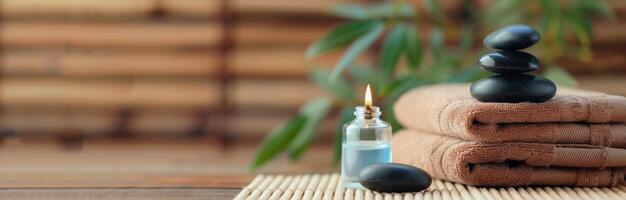 Essential Oil Bottle and Stones on Bamboo Mat in Relaxing Spa Setting photo