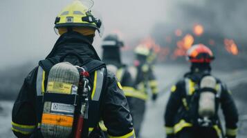 Firefighters in Protective Gear Responding to Industrial Fire at Dawn photo