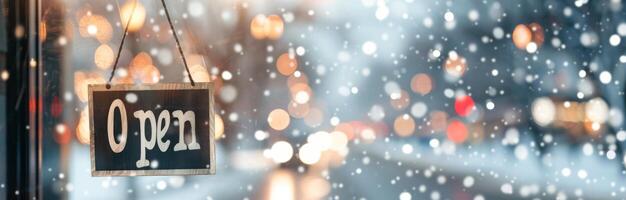 Open Sign Hanging Outside Store During Snowfall in Winter Evening photo