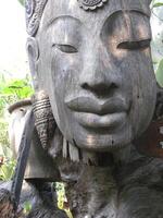 The wood is carved into the shape of a person's face in ancient times. The color is gray wood that has been exposed to the sun and rain over time. photo