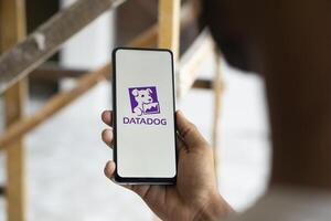 Dhaka, Bangladesh, 11 Aug 2024- DataDog logo is displayed on smartphone. Datadog is a SaaS platform that monitors cloud applications. photo