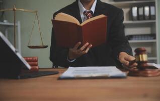 Judge gavel with Justice lawyers having team meeting at law firm background. Concepts of Law and Legal services. photo
