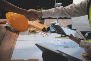 Architect men making handshake in construction site. Employee or worker shake hands to employer man for greeting, dealing, teamwork, collaboration some project or business. They are good team photo