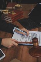 Judge gavel with Justice lawyers having team meeting at law firm background. Concepts of Law and Legal services. photo
