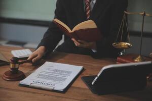 Judge gavel with Justice lawyers having team meeting at law firm background. Concepts of Law and Legal services. photo