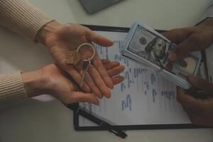 Real estate agent home sales broker is using a pen pointing to the house model and explains the business contract, rent, buy, mortgage, loan, or home insurance photo