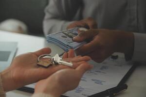 Real estate agent home sales broker is using a pen pointing to the house model and explains the business contract, rent, buy, mortgage, loan, or home insurance photo