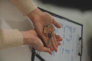 Real estate agent home sales broker is using a pen pointing to the house model and explains the business contract, rent, buy, mortgage, loan, or home insurance photo