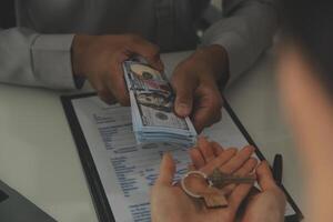 Real estate agent home sales broker is using a pen pointing to the house model and explains the business contract, rent, buy, mortgage, loan, or home insurance photo