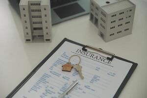 Real estate agent home sales broker is using a pen pointing to the house model and explains the business contract, rent, buy, mortgage, loan, or home insurance photo