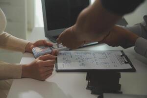 Real estate agent home sales broker is using a pen pointing to the house model and explains the business contract, rent, buy, mortgage, loan, or home insurance photo