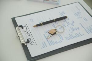 Real estate agent home sales broker is using a pen pointing to the house model and explains the business contract, rent, buy, mortgage, loan, or home insurance photo
