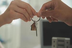 Real estate agent home sales broker is using a pen pointing to the house model and explains the business contract, rent, buy, mortgage, loan, or home insurance photo