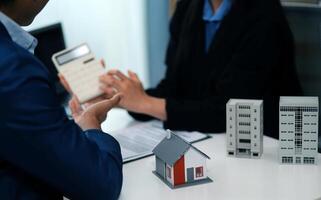 Sale representative offer house purchase contract to buy a house or apartment or discussing about loans and interest rates photo