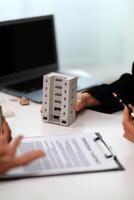 Sale representative offer house purchase contract to buy a house or apartment or discussing about loans and interest rates photo