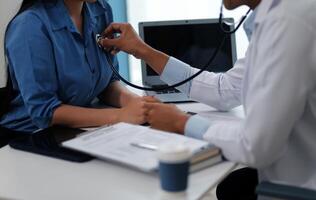 Doctor using a stethoscope checking patient with examining, presenting results symptom and recommend treatment method, Healthcare and medical concept. photo