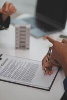 Sale representative offer house purchase contract to buy a house or apartment or discussing about loans and interest rates photo