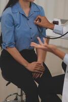 Asian doctor is using a stethoscope listen to the heartbeat of the elderly patient. photo