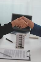 Estate agent shaking hands with customer after contract signature photo