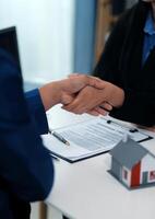 Sale representative offer house purchase contract to buy a house or apartment or discussing about loans and interest rates photo