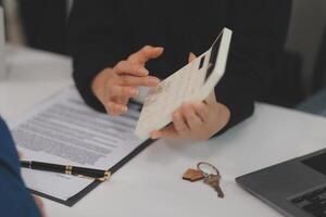 Sale representative offer house purchase contract to buy a house or apartment or discussing about loans and interest rates photo