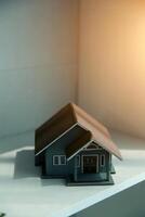 Real estate agent home sales broker is using a pen pointing to the house model and explains the business contract, rent, buy, mortgage, loan, or home insurance photo