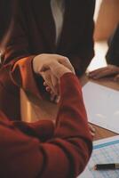 Close up of a team of business people having a meeting to analyze data for a marketing plan. photo