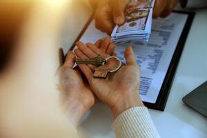Real estate agent home sales broker is using a pen pointing to the house model and explains the business contract, rent, buy, mortgage, loan, or home insurance photo