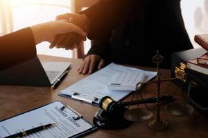 concept of justice and law A male judge in the courtroom on a wooden table and a male counselor or lawyer working in the office. Law, advice and justice concepts. photo