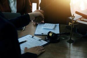concept of justice and law A male judge in the courtroom on a wooden table and a male counselor or lawyer working in the office. Law, advice and justice concepts. photo