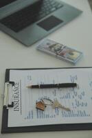 Real estate agent home sales broker is using a pen pointing to the house model and explains the business contract, rent, buy, mortgage, loan, or home insurance photo